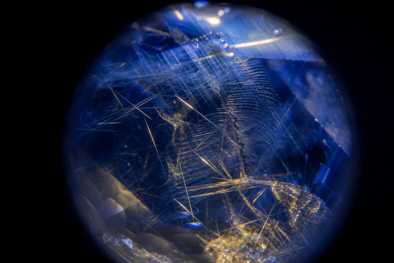 Illustrative macro view of rutile silk and inclusions inside a blue sapphire